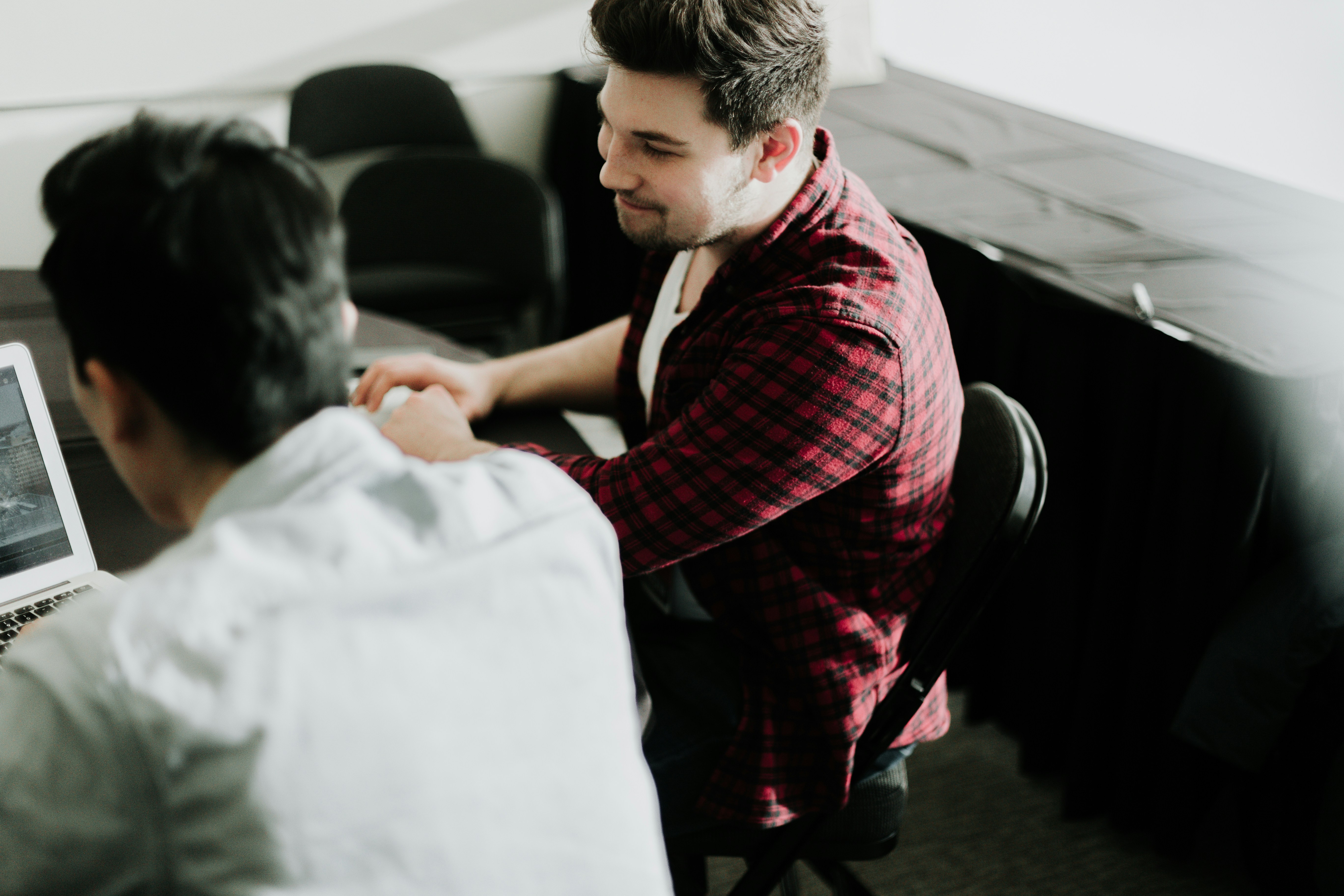 man looking at benefits of deal flow management tool