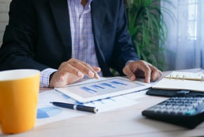 man looking at charts of venture capital portfolio management